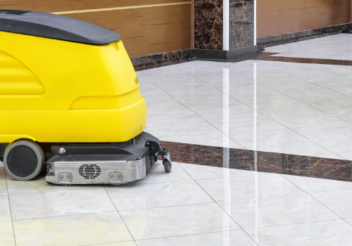 Floor cleaning robot working to clean a commercial floor