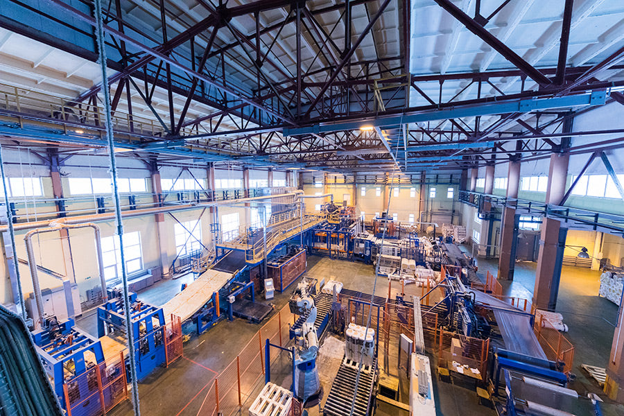 An industrial warehouse floor with pipes and other assorted equipment