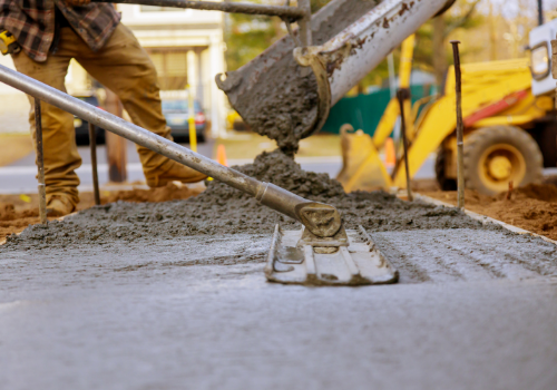 A concrete flatttening tool working on freshly poured concrete